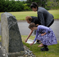 Dame Susan Devoy, New Zealand Race Relations Commissioner, and Mrs Inge Woolf, founding director of the Holocaust Centre of New Zealand, lay stones at the Holocaust Memorial in Wellington’s Jewish Cemetery, together with Mrs Woolf’s grand-daughter Lily-Jane Woolf. (Photo: Photography by Woolf)